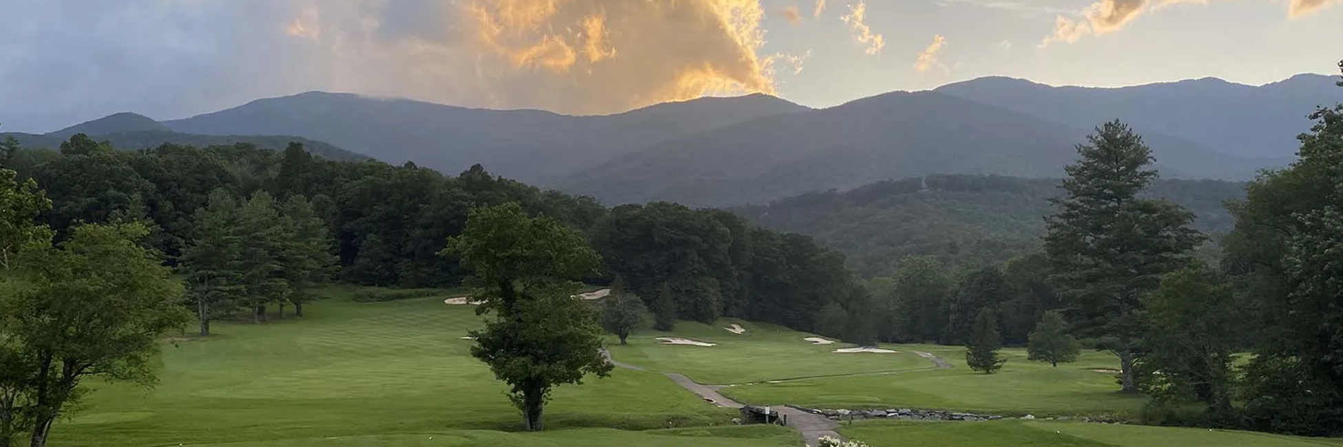 Golf course fairway with mountain in distance